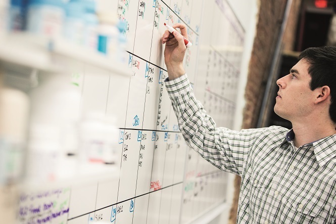 pharmacist at white board calendar